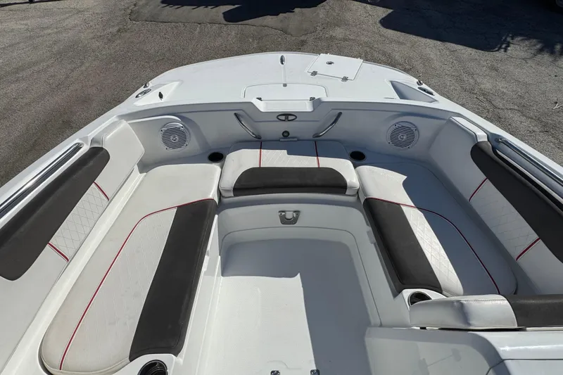 Slide: The Image of 2023 Tahoe 1950 boat interior with cushioned seating and speakers. - 16
