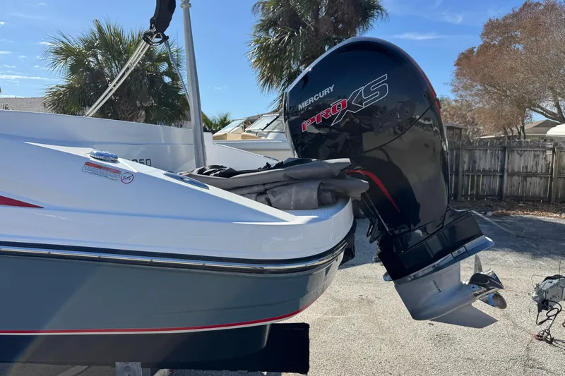 Slide: The Image of 2023 Tahoe 1950 boat with Mercury Pro XS outboard motor, parked outdoors. - 4