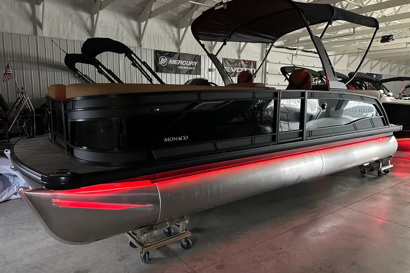 Slide: The Image of 2026 Godfrey Monaco 255 SB boat dashboard with illuminated controls and steering wheel. - 11