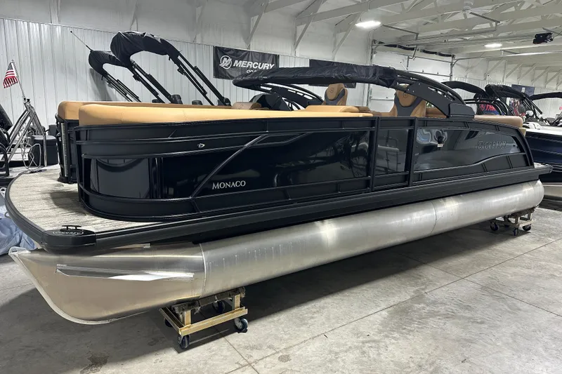 Slide: The Image of 2026 Godfrey Monaco 255 SB pontoon boat with tan seating in showroom. - 17