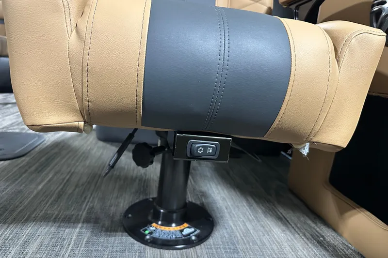 Slide: The Image of Open storage compartment in 2026 Godfrey Monaco 255 SB boat, featuring a black bin and latch. - 19