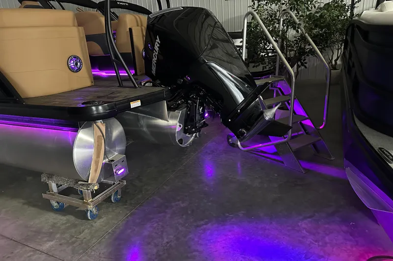 Slide: The Image of 2026 Godfrey Monaco 255 SB boat with purple LED lights and Mercury engine. - 6