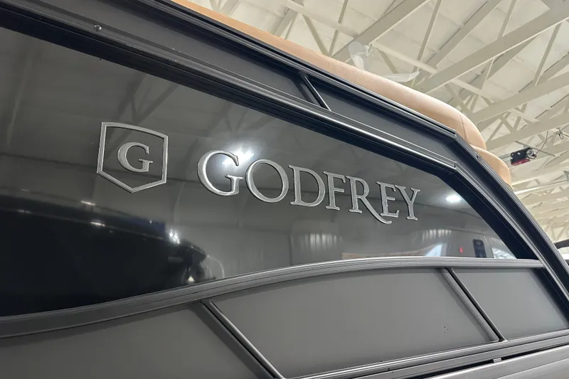 Slide: The Image of 2026 Godfrey Monaco 255 SB boat with sleek design and logo detail. - 7
