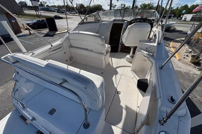 Slide: The Image of 2005 Regal Commodore 2765 boat interior with white seating and steering console. - 12