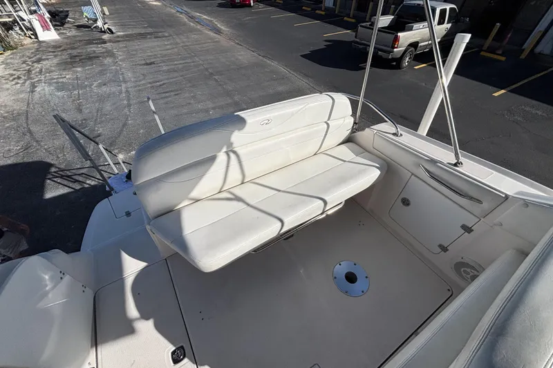 Slide: The Image of 2005 Regal Commodore 2765 boat interior with white seating and storage compartments. - 13