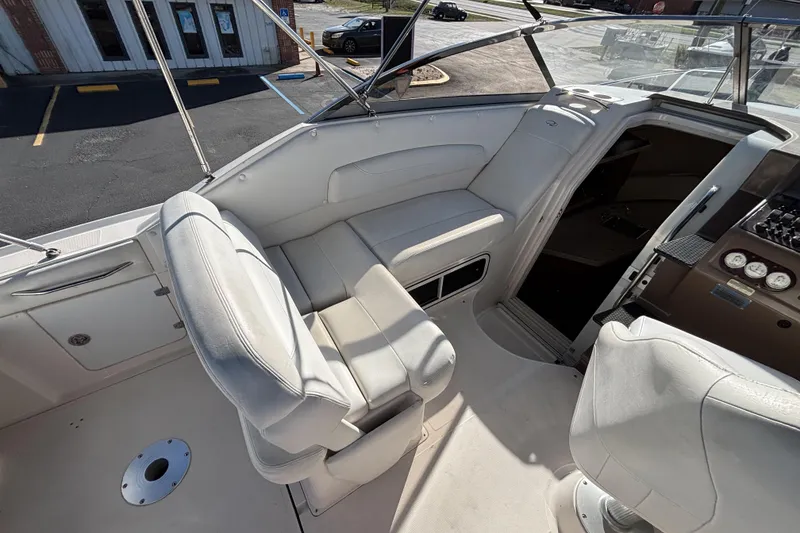 Slide: The Image of Interior of 2005 Regal Commodore 2765 boat with white seating and control panel. - 15