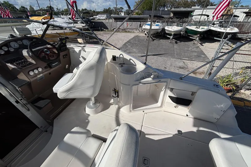 Slide: The Image of 2005 Regal Commodore 2765 boat interior with steering wheel and seating area. - 16