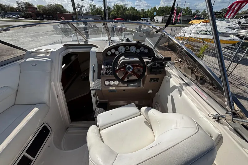 Slide: The Image of 2005 Regal Commodore 2765 boat cockpit with steering wheel and dashboard controls. - 18