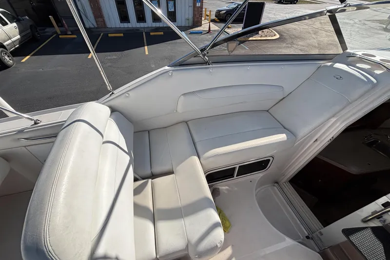 Slide: The Image of 2005 Regal Commodore 2765 boat interior with white seating and windshield view. - 19