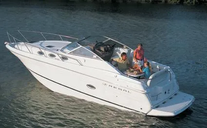 Slide: The Image of 2005 Regal Commodore 2765 boat, rear view, with dual propellers, parked outdoors under a clear sky. - 2