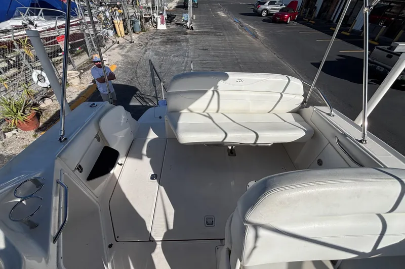 Slide: The Image of 2005 Regal Commodore 2765 boat interior with white seating and dockside view. - 20