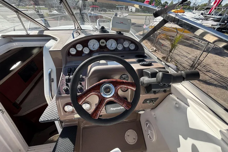 Slide: The Image of 2005 Regal Commodore 2765 boat cockpit with steering wheel and control panel. - 22