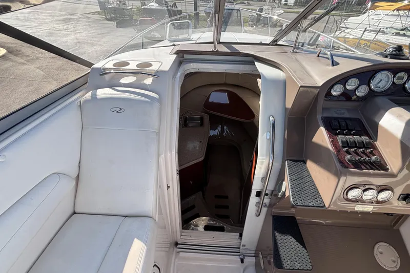 Slide: The Image of 2005 Regal Commodore 2765 boat interior with helm, seating, and cabin entrance. - 23