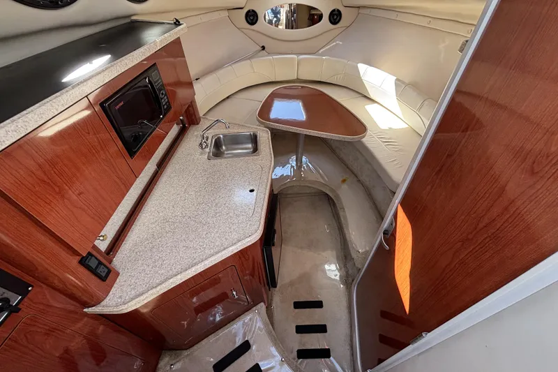 Slide: The Image of 2005 Regal Commodore 2765 cabin interior with kitchenette and seating area. - 25