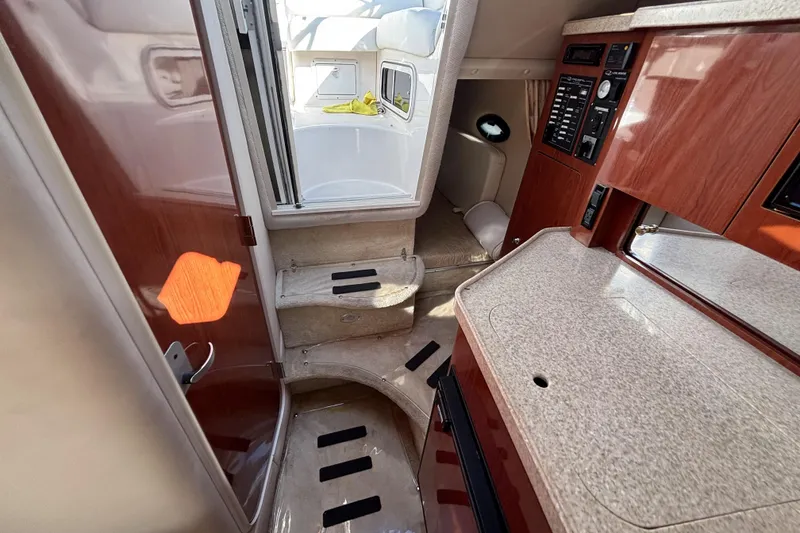 Slide: The Image of Interior of 2005 Regal Commodore 2765 boat with kitchenette and cabin area. - 27