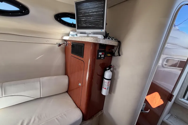 Slide: The Image of 2005 Regal Commodore 2765 cabin interior with TV, seating, and fire extinguisher. - 28