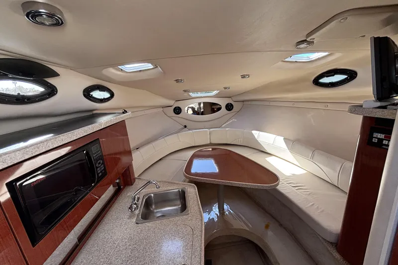 Slide: The Image of Interior of 2005 Regal Commodore 2765 boat with kitchenette and seating area. - 29