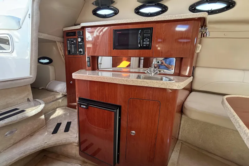 Slide: The Image of Interior of 2005 Regal Commodore 2765 boat with kitchenette and seating area. - 32