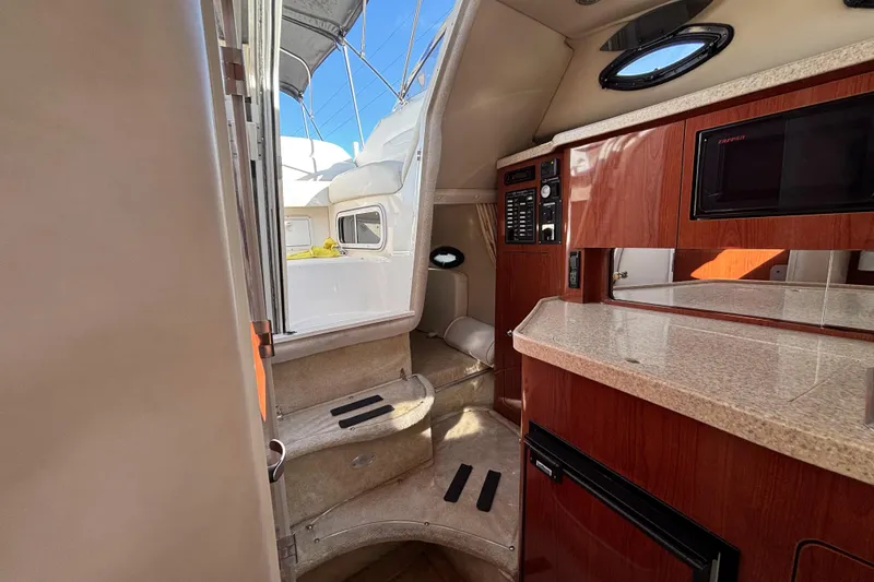 Slide: The Image of Interior of 2005 Regal Commodore 2765 boat with kitchenette and seating area. - 33