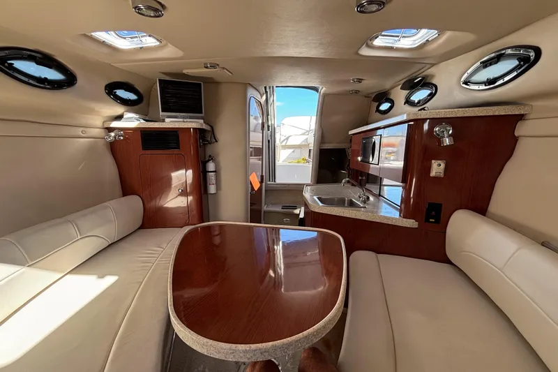 Slide: The Image of Interior of 2005 Regal Commodore 2765 boat with seating, table, and kitchenette. - 34