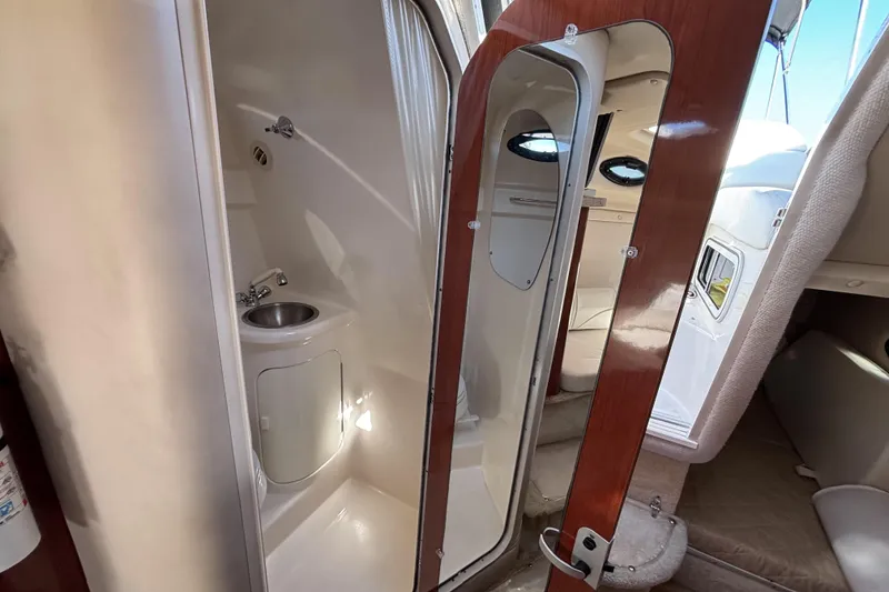 Slide: The Image of 2005 Regal Commodore 2765 boat interior with bathroom and wooden door. - 36