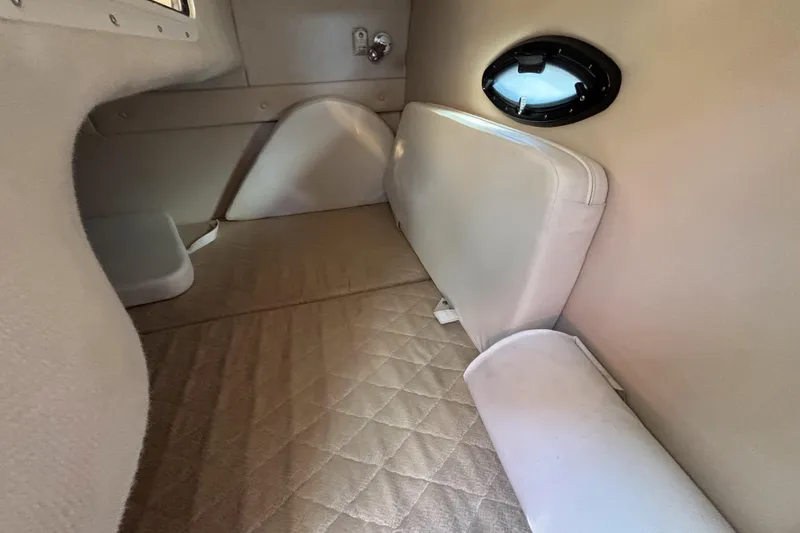 Slide: The Image of Interior cabin of a 2005 Regal Commodore 2765 boat, featuring beige upholstery. - 37