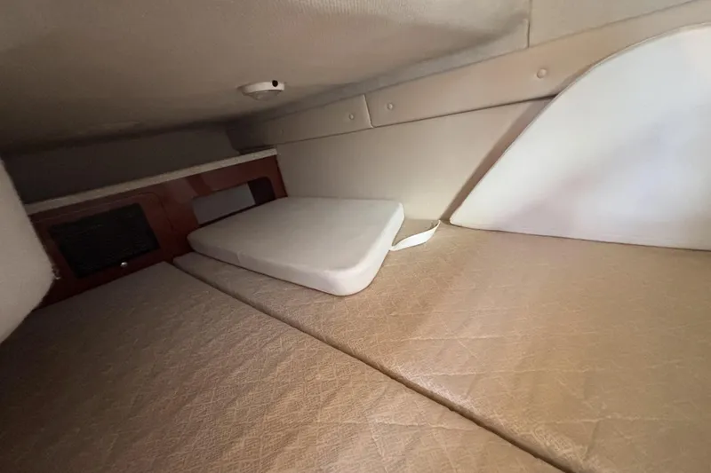 Slide: The Image of 2005 Regal Commodore 2765 cabin interior with beige upholstery and storage space. - 38
