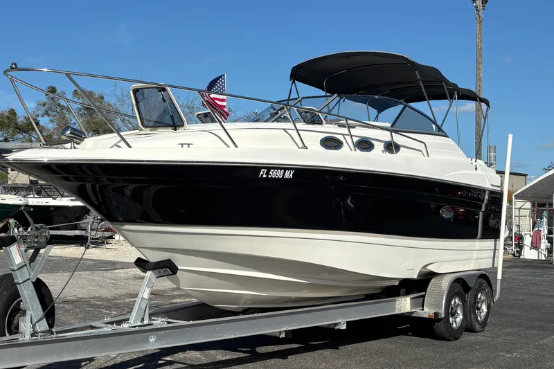 Slide: The Image of 2005 Regal Commodore 2765 boat on trailer, black and white design, parked outdoors. - 6