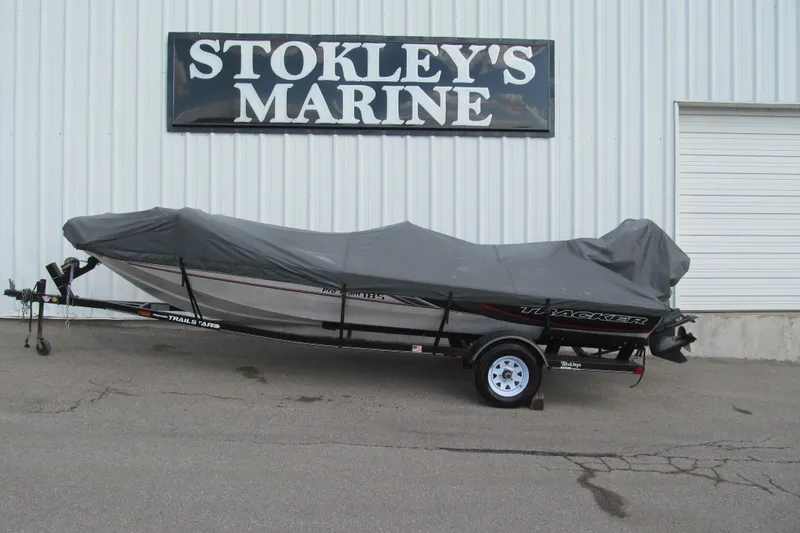 Slide: The Image of 1998 Tracker Pro Team 185 boat covered, parked at Stokley's Marine. - 12
