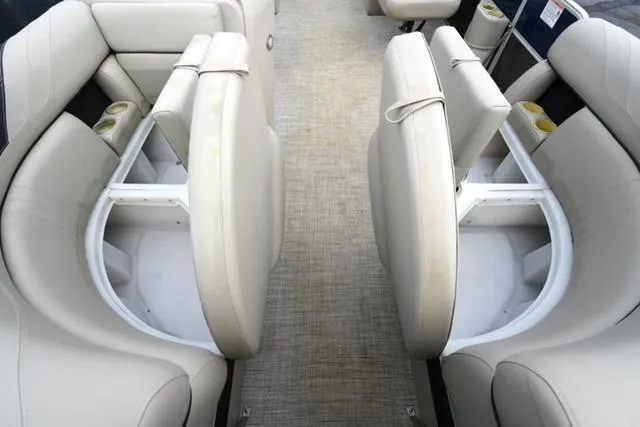 Slide: The Image of 2022 South Bay 222RS LE boat interior with beige seating and cup holders. - 10