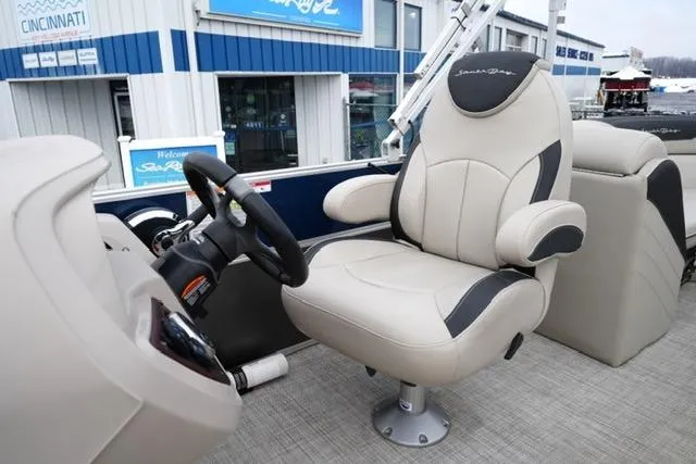 Slide: The Image of 2022 South Bay 222RS LE boat interior with captain's chair and steering wheel. - 12