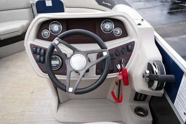 Slide: The Image of 2022 South Bay 222RS LE boat dashboard with steering wheel and control panel. - 13