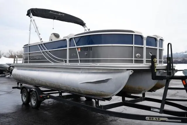 Slide: The Image of 2022 South Bay 222RS LE pontoon boat on trailer, featuring sleek design and canopy. - 3
