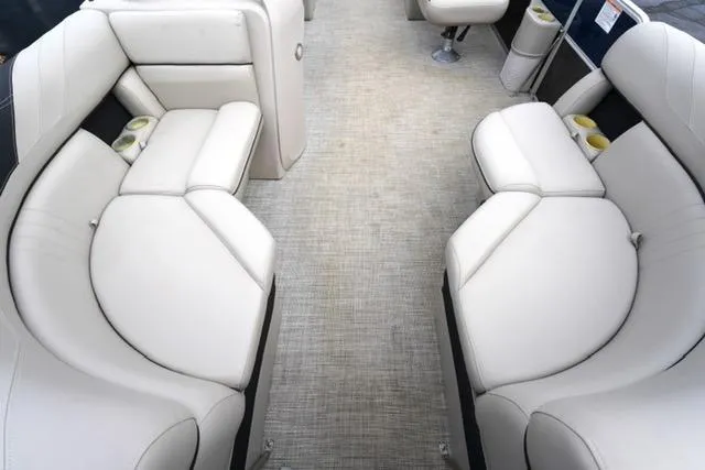Slide: The Image of 2022 South Bay 222RS LE pontoon boat interior with plush seating and cup holders. - 9