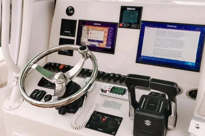 Slide: The Image of 2019 Carolina Skiff 27' Center Console dashboard with steering wheel and navigation displays. - 4