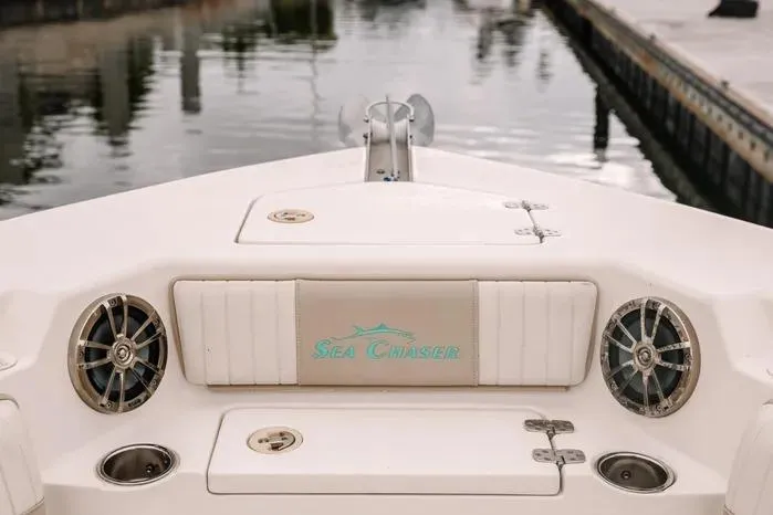 Slide: The Image of 2019 Carolina Skiff 27' Center Console boat with "Sea Chaser" branding at dock. - 6