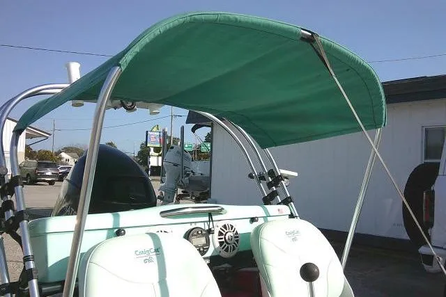 Slide: The Image of 2021 CraigCat E2 Elite with green canopy and dual seats, parked outdoors. - 12