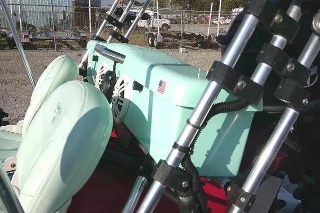 Slide: The Image of 2021 CraigCat E2 Elite with mint green seats and speakers, parked outdoors. - 6