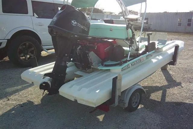 Slide: The Image of 2021 CraigCat E2 Elite with Tohatsu motor on trailer, parked outdoors. - 9
