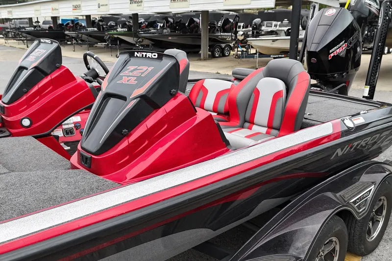 Slide: The Image of 2025 Nitro Z21 XL Pro boat with red and gray seating, displayed in a showroom. - 10