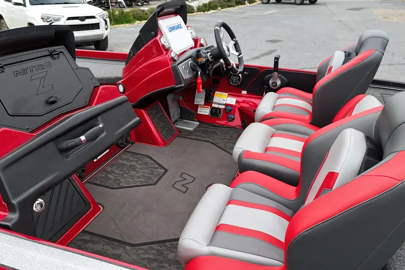 Slide: The Image of 2025 Nitro Z21 XL Pro boat interior with red and gray seating, modern dashboard. - 11