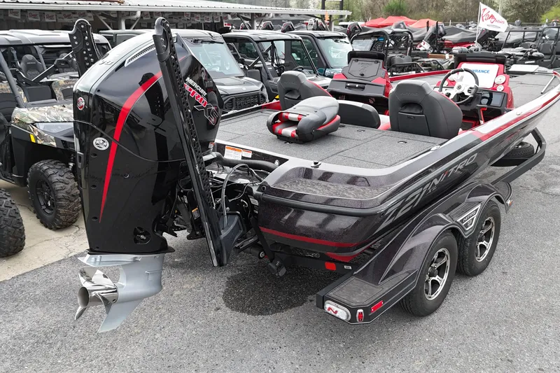 Slide: The Image of 2025 Nitro Z21 XL Pro boat with powerful outboard motor, parked among other vehicles. - 8