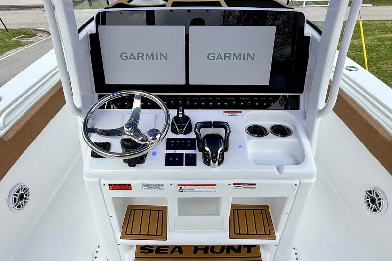 Slide: The Image of 2026 Sea Hunt Ultra 285 SE boat console with dual Garmin displays and steering wheel. - 10