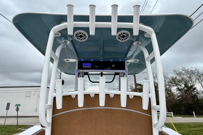 Slide: The Image of 2026 Sea Hunt Ultra 285 SE boat with rod holders and speakers under a blue canopy. - 11
