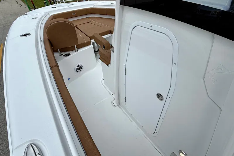 Slide: The Image of 2026 Sea Hunt Ultra 285 SE boat interior with brown seating and white deck. - 12