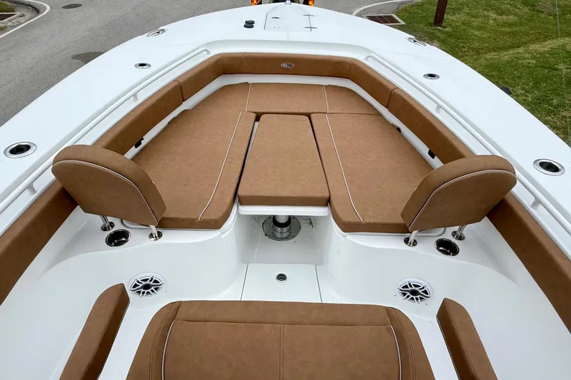 Slide: The Image of 2026 Sea Hunt Ultra 285 SE boat with tan cushioned seating and white deck. - 14