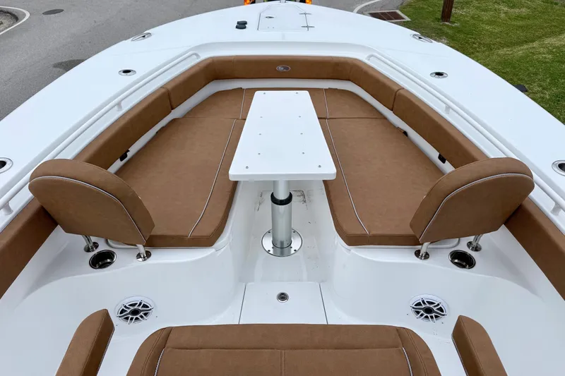 Slide: The Image of 2026 Sea Hunt Ultra 285 SE boat interior with brown seating and white table. - 15