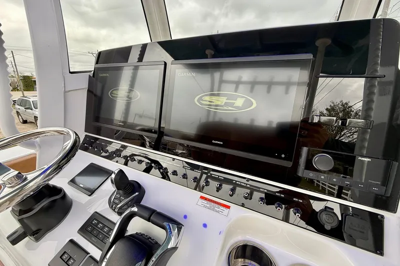 Slide: The Image of 2026 Sea Hunt Ultra 285 SE dashboard with dual Garmin displays and control panel. - 18