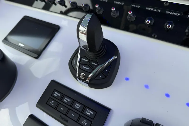 Slide: The Image of Control panel of 2026 Sea Hunt Ultra 285 SE boat with joystick and switches. - 20