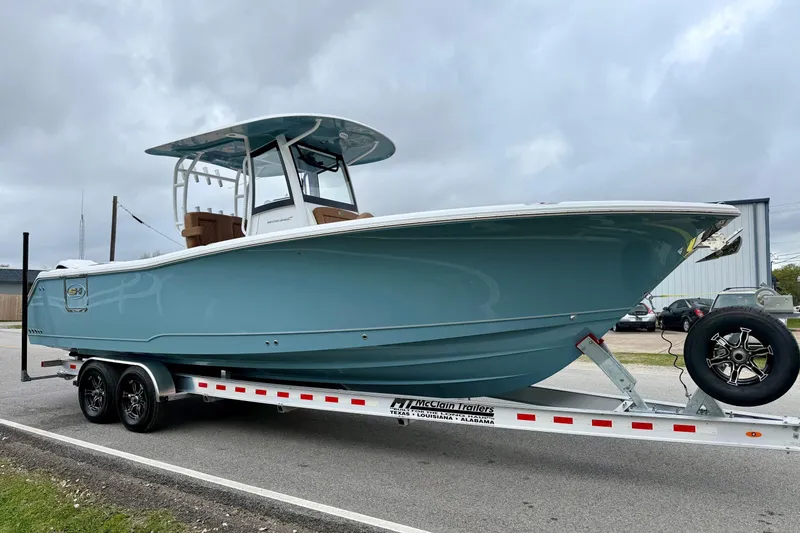 Slide: The Image of 2026 Sea Hunt Ultra 285 SE boat on trailer, parked outdoors under cloudy sky. - 5